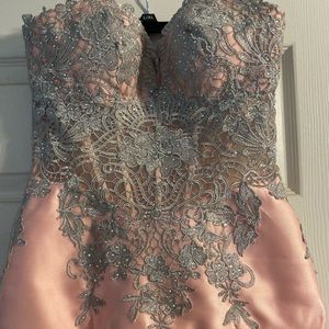 Pink prom dress with sheer bodes and corset back.